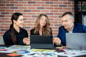 Marketing team reviewing PPC campaign performance dashboards on a laptop.